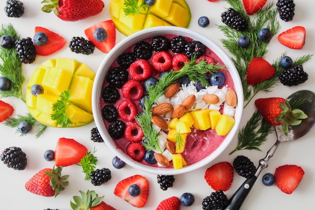 A bowl of smoothie with an assortment of food toppings.