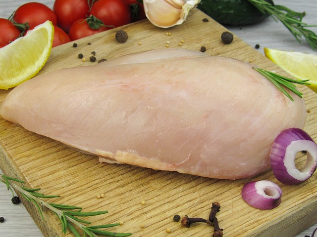 Raw chicken fillet on a cutting board.