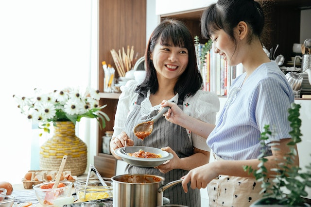 Mother and daughter cooking in the kitchen