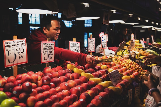 Person buying fruits at the market