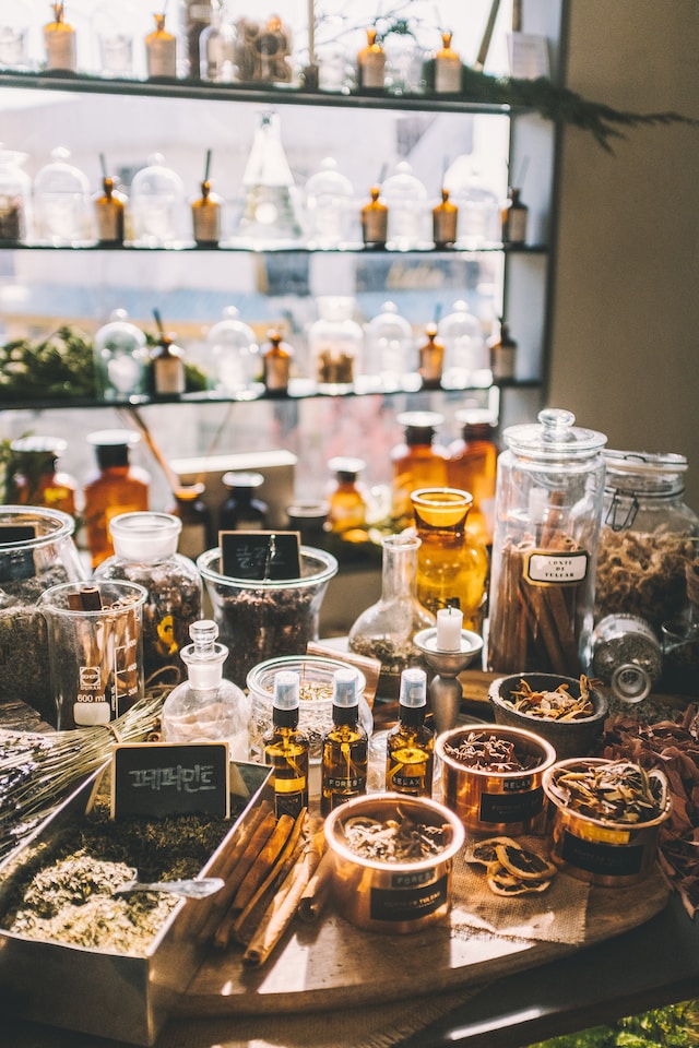 An assortment of herbal remedies inside different containers on a table