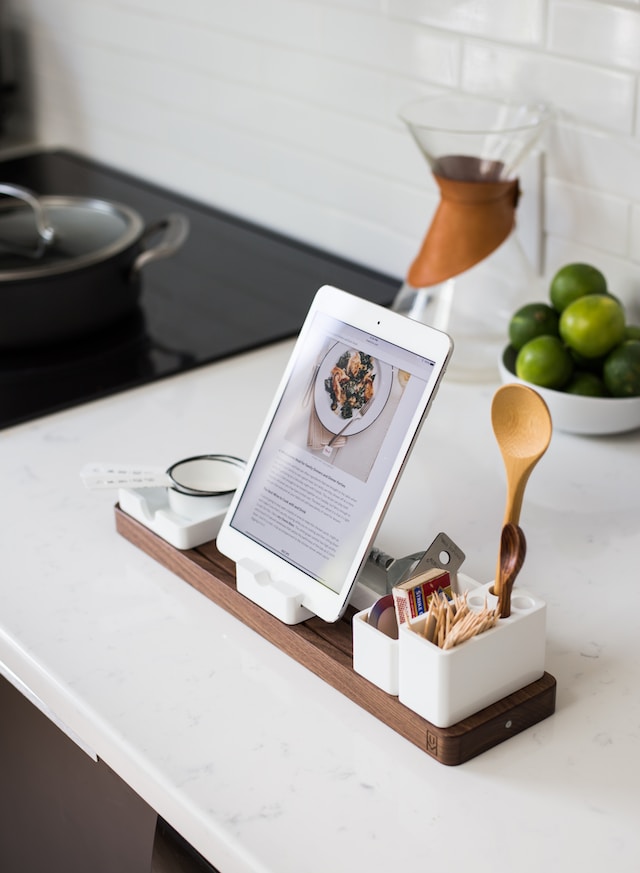 A mobile device displaying a recipe on a kitchen counter