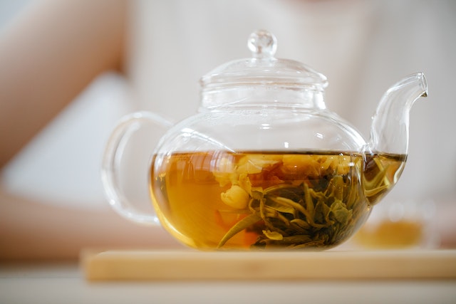 Herbal tea seeping inside a glass pot