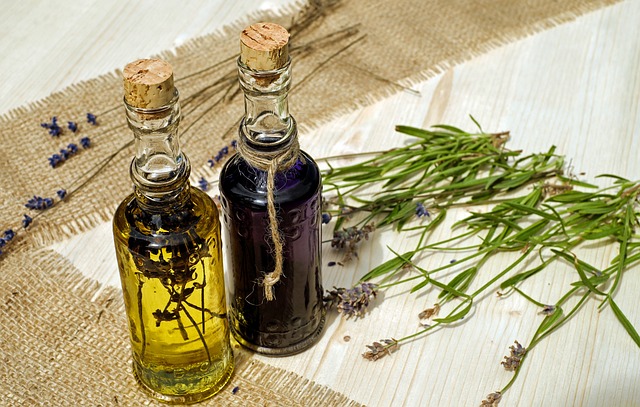 Dried herbs seeped in oil inside small clear glass bottles