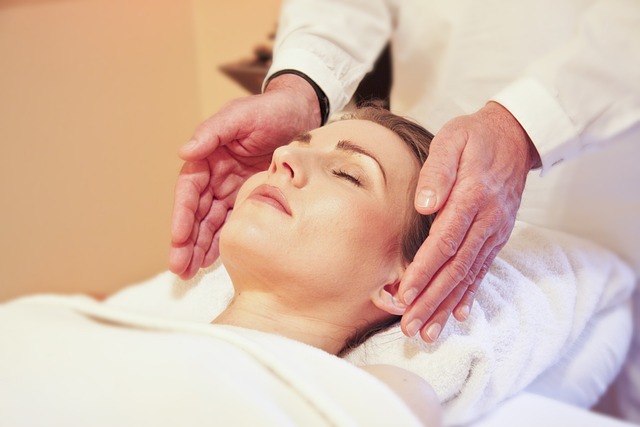 A  woman being healed through the hands-off reiki technique