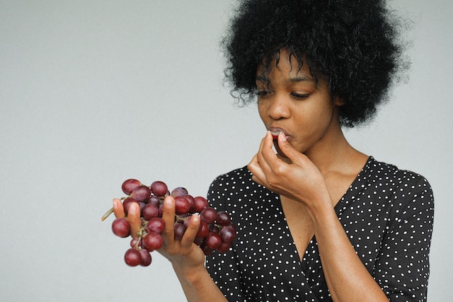 Woman eating some grapes