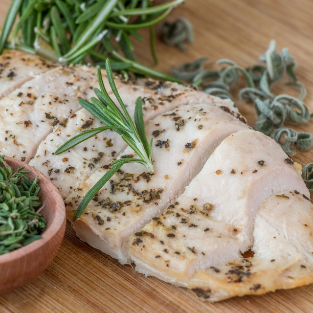 Cooked chicken breast seasoned with herbs and spices