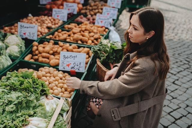 
Woman buying vegetables at a market